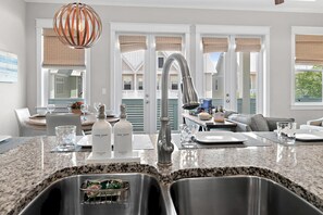 Eine Küche mit Granit-Arbeitsflächen, Edelstahl-Spülen und einem modernen Wasserhahn.