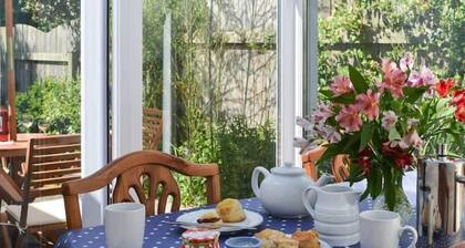 Honeysuckle Cottage with optional hot tub and shared EV charger.