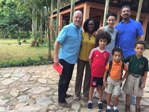 A group of people standing in a courtyard with stone flooring and greenery. - The Tree House B&B, Aburi (2 extra rooms). (aburi)