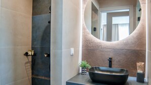 A modern bathroom with a large mirror, a black sink, and a shower area. - BITTER ALMOND TREES VILLAS - Stylish villa, sea views 1000m from Nikiana & Beach (Lefkada)