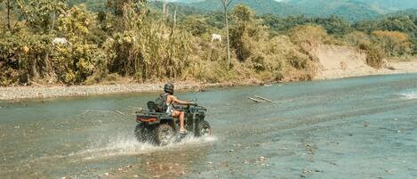 A river with a vehicle crossing it.
