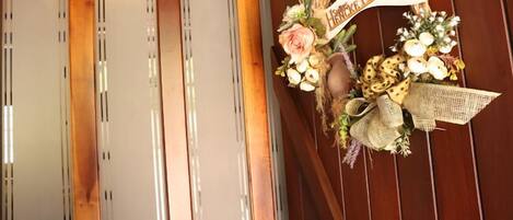 A wooden door with a decorative wreath and a sign that reads "Husband & Wife."