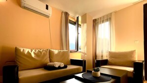 A modern living room with a beige sofa, a coffee table, and a TV stand. - Apartment B25, Bansko, Royalpark (Bansko)