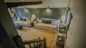 A spacious living room with a sofa set, a coffee table, and a lamp. - The Piggery - stylish barn conversion in the heart of the High Peak (Tideswell)