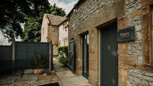 A stone building with a sign reading "The Piggy." - The Piggery - stylish barn conversion in the heart of the High Peak (Tideswell)