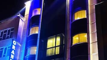GRAND HOTEL features a modern facade with multiple floors and balconies.