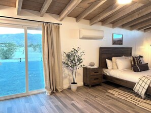 Enjoy breathtaking mountain views from the comfort of this cozy retreat, featuring a plush bed and natural ambiance.