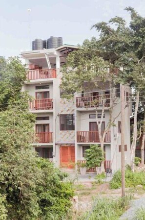 Residents enjoy balconies with outdoor space and lush surroundings.