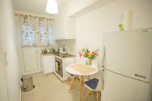 Enjoy meals in the compact kitchen with an oven and dining area.