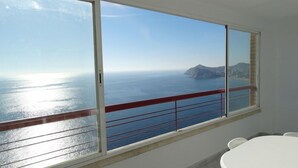 A room with a large window overlooking a coastal view. - Apartamentos Beni Beach (Benidorm)