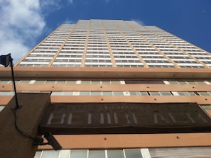 A tall building with a prominent 'BENEFICIAL' sign on the lower facade.