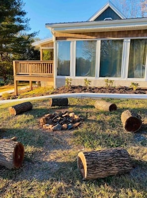 Enjoy a peaceful retreat with a fire pit and expansive views from the large windows.