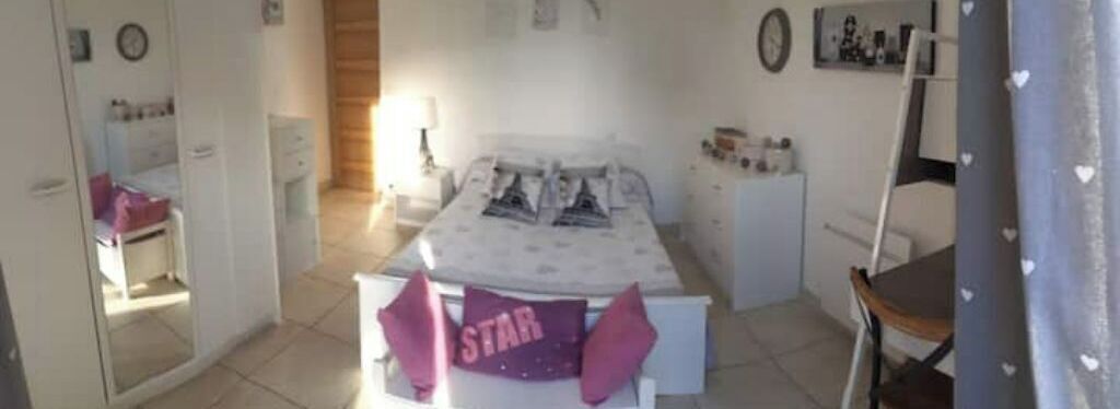 A bedroom with a bed, a dresser, a chair, and a desk.