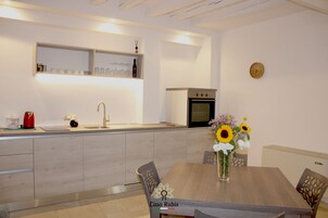 Family Townhome | Private kitchen | Electric kettle, highchair