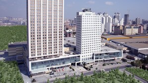A modern hotel with a central glass facade, multiple floors, and a parking area. - Tuyap Palas (Istanbul)