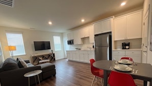 A modern apartment with a living room, dining area, and kitchen. - Lakeview Retreat: Golf, Fish, & Explore the Trails (Sparks)