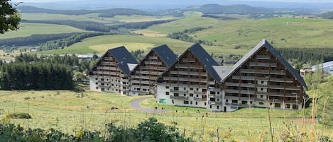 Situated in a serene valley, this resort offers stunning views of rolling hills and lush green surroundings.