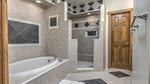 Bathtub, hair dryer, towels, toilet paper