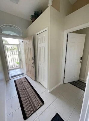 Stylish hallway with simple doors and a cozy area rug.