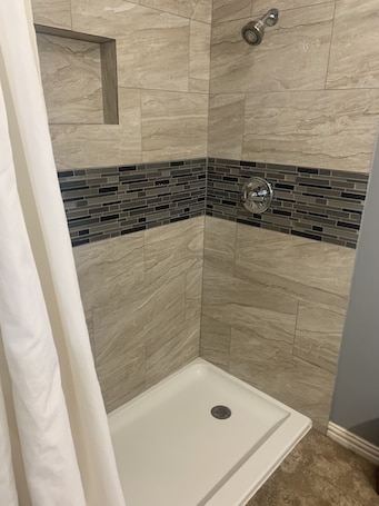 Rainfall showerhead, hair dryer, towels, soap. Hickman's Motel