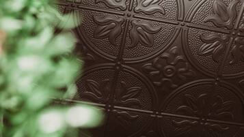 A close-up of a decorative metal panel with intricate floral patterns.