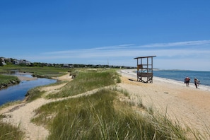 A beach with a lifeguard tower, a sandy path, and a calm body of water. - Gorgeous Home with Game Room Dog Welcome! (Chatham)