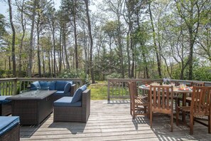 Relax on the outdoor deck with a sofa and dining area.