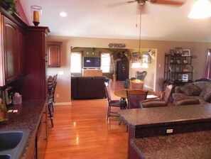 Relax in this inviting living area with a dining table, sofa, and armchairs.