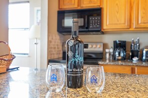 A bottle of Table Rock Lager on a kitchen counter with two glasses.