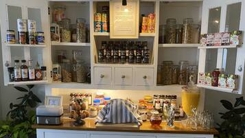 A kitchen with shelves stocked with jars of spices, condiments, and canned goods.