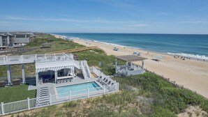 A beachfront property with a pool, beach access, and a gazebo. - 5373 - Wench's Pad 4 - Luxury Oceanfront Retreat | Sleeps 40 (Kill Devil Hills)