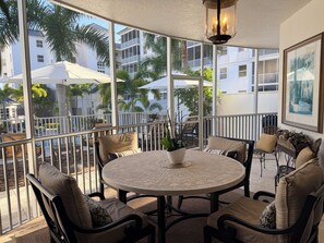 Outdoor dining - Enjoy a Poolside Luxury Condo and dock, & only a 3 min walk to Vanderbilt Beach. (Naples)