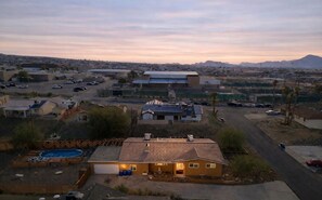 Un quartier résidentiel avec des maisons, une piscine et un grand immeuble.