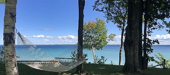 Dog-friendly secluded home near Suttons Bay with water views, firepit, fireplace