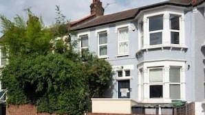 A two-story residential building with a bay window on the ground floor. - Lovely 1Bed Flat - Green Lanes - Spacious and Quiet (Greater London)