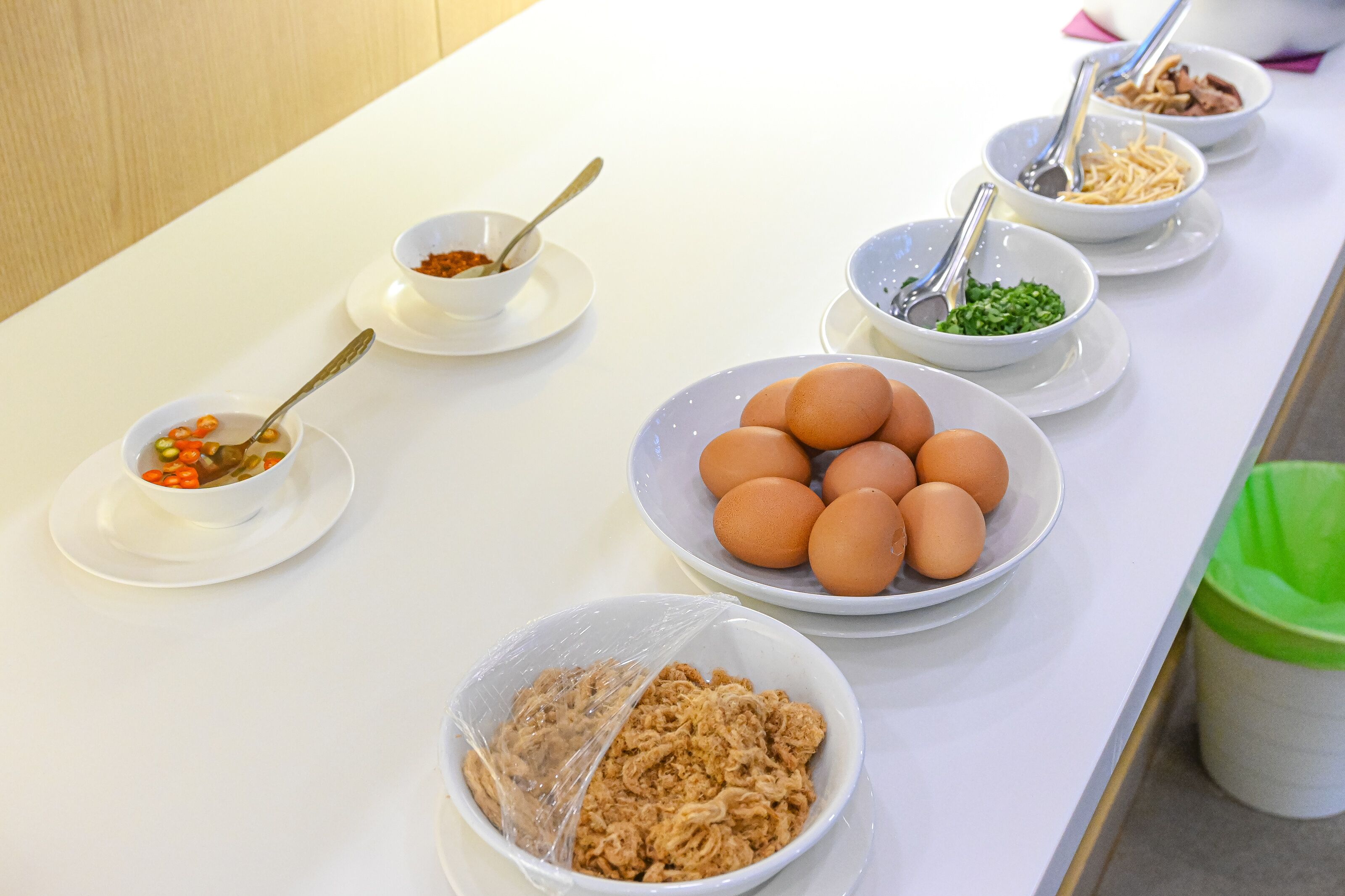 A breakfast buffet with various food items and utensils.