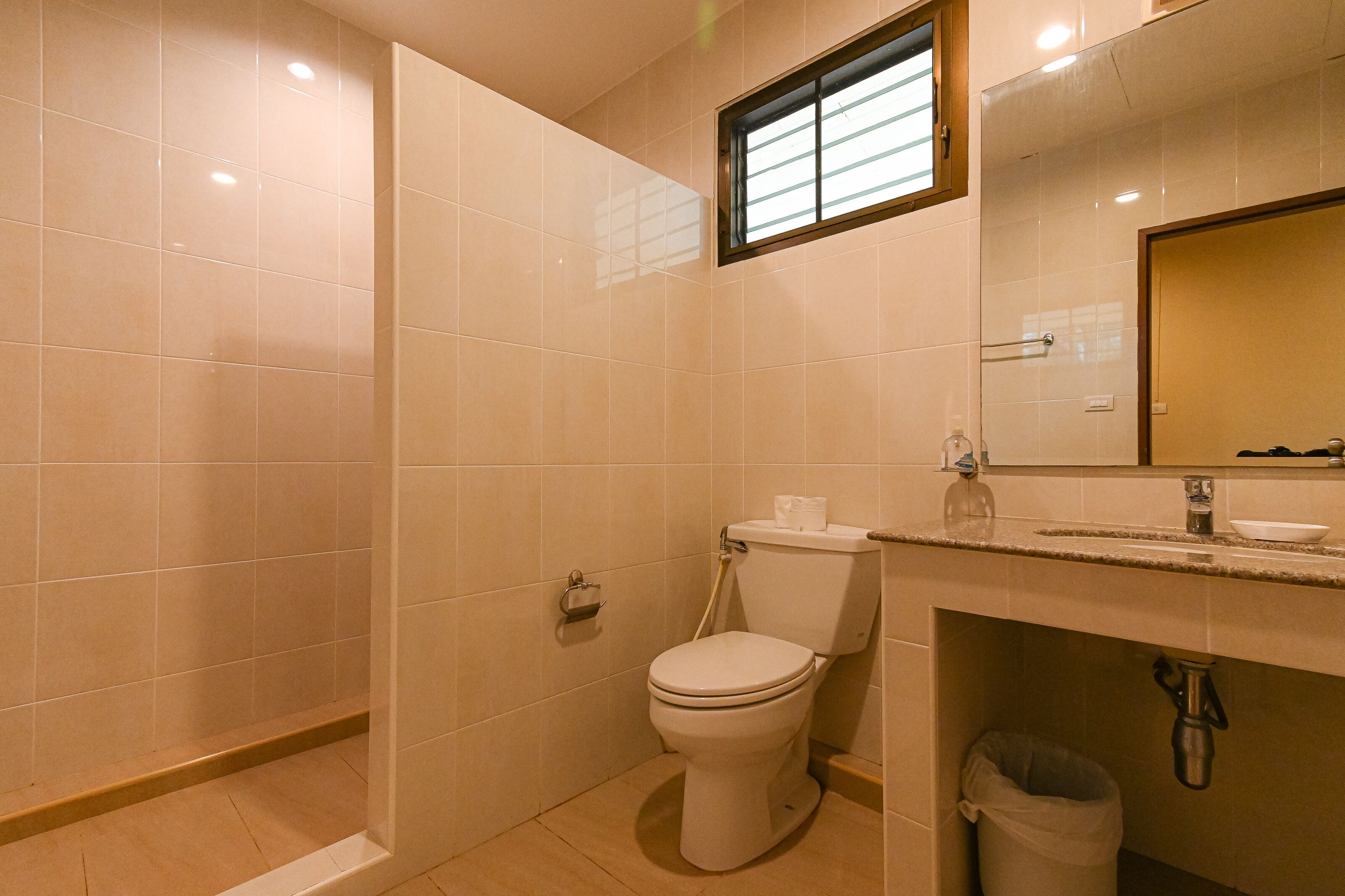 A bathroom with a toilet, sink, and shower.