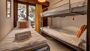 A room with bunk beds, a window with curtains, and a hanging light fixture. - Appartement LaForet 86 - La Tzoumaz, 4 Vallees (La Tzoumaz)