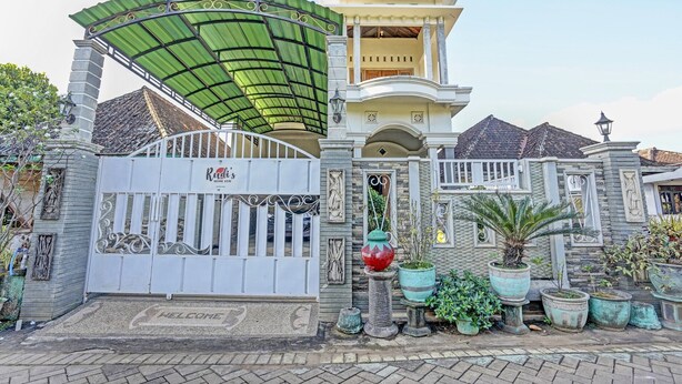 A gated entrance with a "Welcome" mat, a covered porch, and potted plants. - Hotel O Desa Wisata Alam Gosari (wagos) (Gresik)
