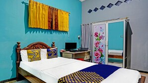 A bedroom with a bed, a desk, a computer, and a wardrobe. - Hotel O Desa Wisata Alam Gosari (wagos) (Gresik)