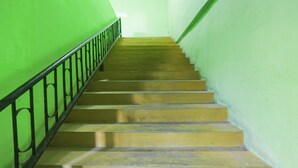 A staircase with green walls and a metal railing. - Hotel O Bilqis Homestay NearThe Hot River, Dog Run (Batam)