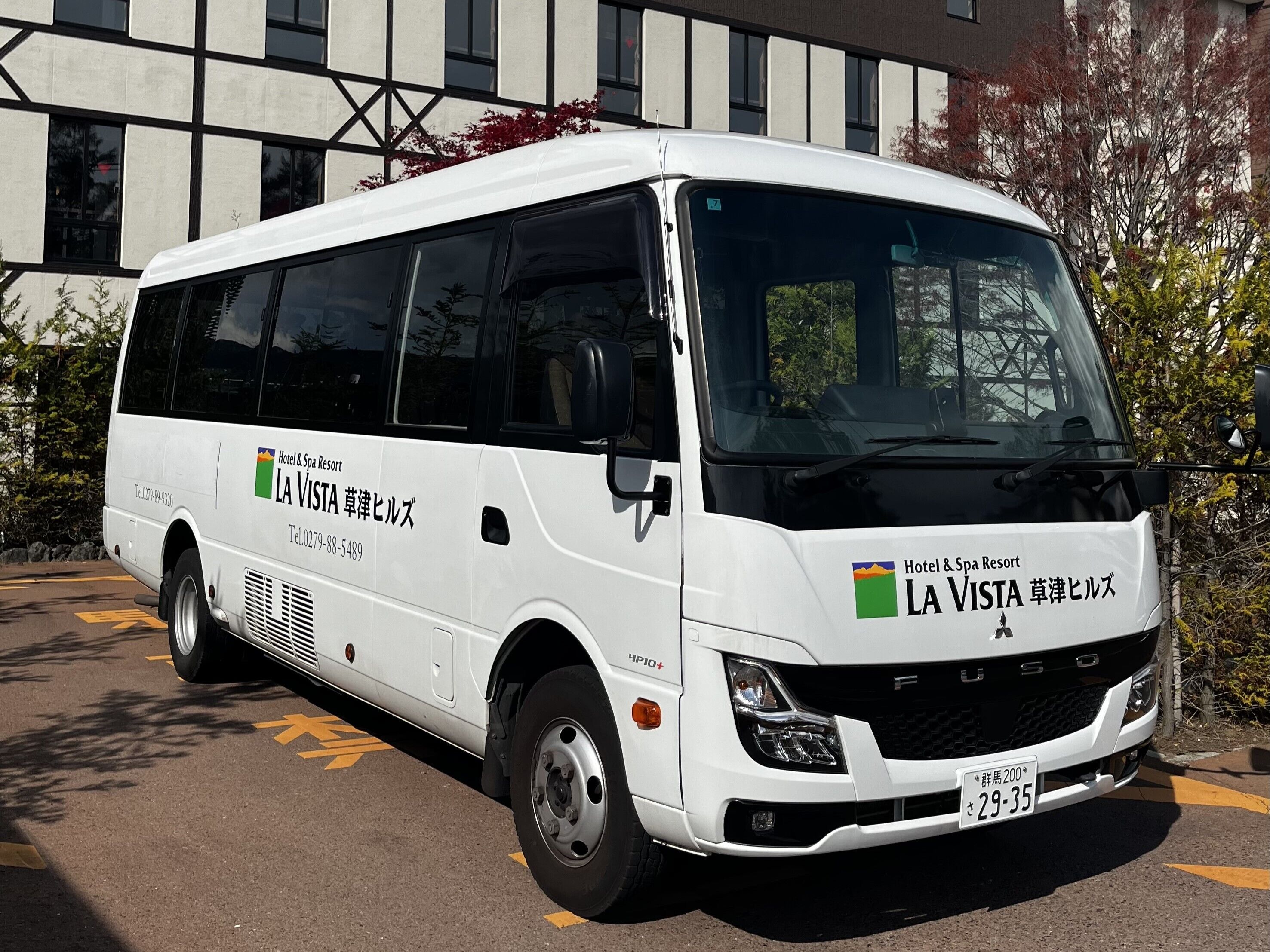 A white La Vista Hotel & Spa Resort bus parked in a lot.