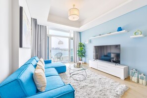 Ultra Deluxe Palm 2BR Apartment | Living area | 50-inch Smart TV with cable channels, TV