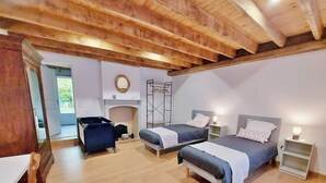 A bedroom with two beds, a wooden ceiling, a mirror, and a wardrobe. - Family Retreat with Garden, Near Leisure Activities (Saint-Poix)