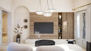 Un salon moderne doté d’un grand téléviseur, de sièges confortables et d’une plante décorative.