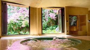 A spa area with a large window, a hot tub, and a reception desk. - The May Legend Catba (Hai Phong)