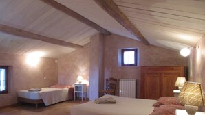 A bedroom with two single beds, a wooden ceiling, a small window, and a radiator. - Charming village house near Bédoin, at the foot of Mont Ventoux (Crillon-le-Brave)