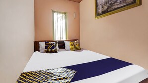 Una habitación de hotel con una cama, un ventanal y un cuadro en la pared.