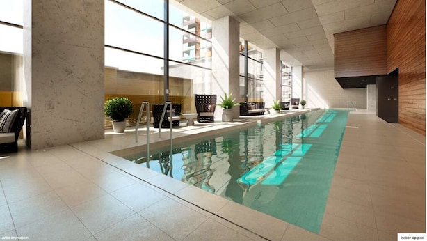 An indoor lap pool with clear glass walls, modern seating, and potted plants. - Luxury 2B2B Well Furnished Spectacular View (Melbourne)