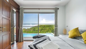 A bedroom with a large window, a bed, a nightstand, and a view of a swimming pool and greenery. - 3BR Villa Mikia SDV007 By Samui Dream Villas (maenam)